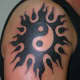 Sun and yin yang tribal tattoo