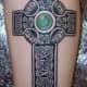 A black cross with a green gem. (by Brian Chadwick, Castle of Color, Nicholasville, KY)