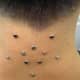 An Inverted Star-Shaped Nape Piercing