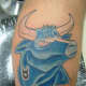 Here, the Taurus symbol is merged with a tattoo of a blue bull.