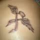 Pink ribbon tattoo stylized as angel wings and halo.