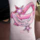 Pink ribbon tattoo with stars commemorating a loved one.