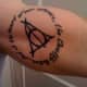 Deathly Hallows tattoo with quote: &quot;And at the heart of our schemes, the Deathly Hallows&quot;