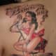 This pinup girl has an inspirational message inscribed above and below her.