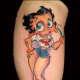 A "Betty Boop"-inspired pinup girl tattoo.