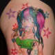 This pinup girl tattoo has a punk rock style.