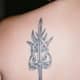A sword tattoo with decorative elements.