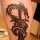 Another sword-and-dragon tattoo.