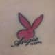 This tattoo features a silhouette of the bunny along with some text.