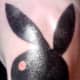 A solid black Playboy bunny tattoo.