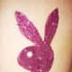 A glittery pink Playboy bunny tattoo.