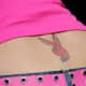 A pink Playboy bunny tattoo on the lower back.