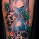 Blue sand in hourglass tattoo