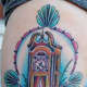 Grandfather clock tattoo with plants.