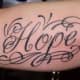 Stylized "hope" tattoo.