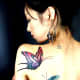 Butterfly tattoo on shoulder of woman