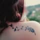 Dandelion tattoo on back of shoulder