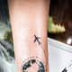 Airplane and Earth tattoo.