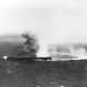 The Japanese carrier Shōkaku, at high speed and turning hard, has suffered bomb strikes and is afire by American carrier based aircraft.
