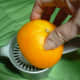The orange juice is squeezed from the orange.