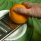 The orange rind is grated to produce orange zest.