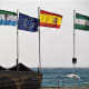 Flags flutter in the sea breeze on the beach at Torremolinos.