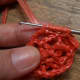 To make a bullion stitch: Pull yarn from under ch-5 sp to anchor the bullion.