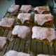 Add pink food dye to the icing. When the bars have cooled to room temperature, lather the tops with the icing.