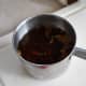 Make a hot cup of rose chai. Set it aside. When it is cool enough to drink, it is ready to be mixed into your icing.