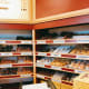 As soon as you enter the donut shop, you've got to see the scrumptious and sugary donuts displayed on the shelves. Yum!