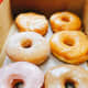 Yummy! There are strawberry glazed, sugar-glazed, maple glazed, raspberry-filled, and sugar donuts in this box. 