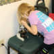 Children taking turns looking at cells under a microscope