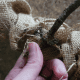 Flip your wreath over and attach your antlers using hot glue. It's helpful to add a scrap piece of burlap under the wire where you're gluing.