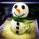 This cheeseball snowman has a green scarf made out of scallions.