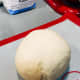 Remove the dough from the hook and transfer it to a mat or floured surface.