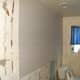 In the end, it was cheaper and easier to simply put a new 'skin' of thin drywall over the top of the old, shoddy wall . This time, done right. Drywall can be had in 1/4" thickness, so overall, the room "shrunk" by a total of only 1/2'.