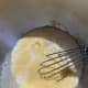 Add in the milk and yeast mixture and whisk until fully incorporated.
