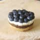 Christmas pudding cheesecake is fully topped with blueberries