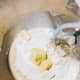 Transfer the mixture to the stand mixer with a hook attachment. Combine the all-purpose flour, pastry flour, half of the butter, and sugar. Mix using a low speed.