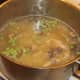 Frozen peas are added to simmering soup