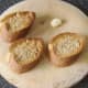 Garlic is rubbed on toasted wholemeal bread slices
