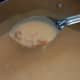 Add milk in incriments, and stir vigorously to blend flour/roux. Reduce heat and stir frequently until gravy has thickened. Add additional liquid if needed.