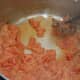 Add tomatoes, which will quickly steam and liquid will be absorbed into flour, like a roux.  