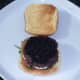 Caviar is spread on beef burger