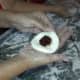 6. After the mochi is in a flattened mound, some of the anko is put in the center.