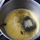 When you add the grounded-down tea into the milk and butter, you'll get dark blue coloring. After stirring it, it will turn greenish.