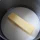 Pour milk into a saucepan. Place in the butter to melt. 