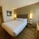 The room. A king-size bed with premium bedding sheets.