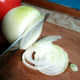 Utility knife slicing an onion