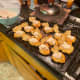 Step 4 cont: Spoon the cream into each sliced profiterole.